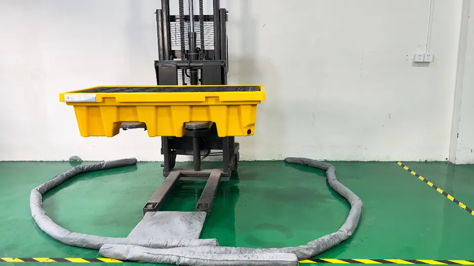 Put absorbent socks and pads under the spill containment pallet